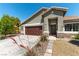 Inviting front yard with desert landscaping, stone accents, and a welcoming entrance with a wreath on the door at 3300 Uribe St, Las Vegas, NV 89129