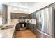 Updated kitchen with stainless steel appliances, gray cabinetry, and a seamless transition to an open layout under recessed lights at 3300 Uribe St, Las Vegas, NV 89129