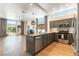 Modern kitchen with stainless steel appliances, gray cabinets, an island and large windows, all under high ceilings at 3300 Uribe St, Las Vegas, NV 89129