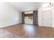 Well-lit living area with wood floors, large windows dressed with curtains, and a view of the front yard at 3300 Uribe St, Las Vegas, NV 89129