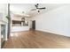 Bright living room with wood floors, modern ceiling fan and an open floorplan to kitchen at 3300 Uribe St, Las Vegas, NV 89129