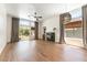 Sunlit living room featuring hardwood floors, a modern light fixture, a cozy fireplace, and access to the outdoor space at 3300 Uribe St, Las Vegas, NV 89129
