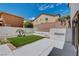 Low maintenance backyard with artificial grass, concrete patio, perfect for outdoor entertaining at 3365 Moon Eclipse St, North Las Vegas, NV 89032