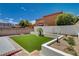 Serene backyard with artificial turf, perfect for relaxing and enjoying outdoor activities at 3365 Moon Eclipse St, North Las Vegas, NV 89032