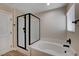 Well-lit bathroom featuring a glass enclosed shower and a separate soaking tub at 3365 Moon Eclipse St, North Las Vegas, NV 89032