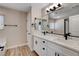 Bathroom with double sinks, marble countertops, stylish fixtures, and ample storage at 3365 Moon Eclipse St, North Las Vegas, NV 89032