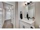 Modern half bathroom with white vanity, dark hardware, and contemporary mirror at 3365 Moon Eclipse St, North Las Vegas, NV 89032