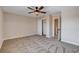 Inviting bedroom with neutral carpet, ceiling fan, and an open closet for easy organization at 3365 Moon Eclipse St, North Las Vegas, NV 89032
