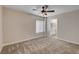 Spacious bedroom with plush carpet, a ceiling fan, and natural light from a window at 3365 Moon Eclipse St, North Las Vegas, NV 89032