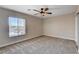 Spacious bedroom with a ceiling fan and natural light from a large window at 3365 Moon Eclipse St, North Las Vegas, NV 89032