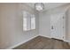 Bright, neutral room featuring modern lighting, wood floors, and a large window at 3365 Moon Eclipse St, North Las Vegas, NV 89032
