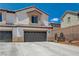 Two-story home featuring a neutral color scheme, a two-car garage, and a tile roof at 3365 Moon Eclipse St, North Las Vegas, NV 89032