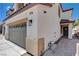 The side of this home shows a two-car garage, stucco siding and a tile roof at 3365 Moon Eclipse St, North Las Vegas, NV 89032
