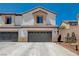Two-story home featuring a neutral color scheme, a two-car garage, and a tile roof at 3365 Moon Eclipse St, North Las Vegas, NV 89032