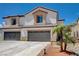 Two-story home featuring a neutral color scheme, a two-car garage, and a tile roof at 3365 Moon Eclipse St, North Las Vegas, NV 89032