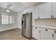 Bright kitchen with modern stainless steel refrigerator and white cabinetry at 3365 Moon Eclipse St, North Las Vegas, NV 89032