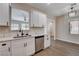 Modern kitchen featuring white cabinets, stainless steel appliances, and quartz countertops at 3365 Moon Eclipse St, North Las Vegas, NV 89032