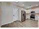 Bright kitchen features white cabinetry, stainless steel appliances, and laminate flooring at 3365 Moon Eclipse St, North Las Vegas, NV 89032