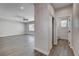 Spacious living room with modern flooring, neutral walls, and access to a bathroom at 3365 Moon Eclipse St, North Las Vegas, NV 89032