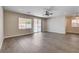 Open living room with laminate floors, natural light, and access to backyard at 3365 Moon Eclipse St, North Las Vegas, NV 89032