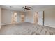 Spacious primary bedroom with plush carpeting, ceiling fan, and ensuite bathroom at 3365 Moon Eclipse St, North Las Vegas, NV 89032