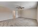 Spacious primary bedroom with plush carpeting, ceiling fan, and ensuite bathroom at 3365 Moon Eclipse St, North Las Vegas, NV 89032