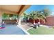 Spacious backyard with a covered patio, desert landscaping and artificial turf at 3425 Fledgling Dr, North Las Vegas, NV 89084