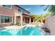 Inviting backyard with a refreshing pool, covered patio, and well-manicured landscaping at 3425 Fledgling Dr, North Las Vegas, NV 89084