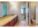 Well-lit bathroom featuring double sinks, ample counter space, and tiled flooring at 3425 Fledgling Dr, North Las Vegas, NV 89084
