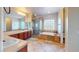 Elegant bathroom with dual vanities, a glass enclosed shower, and a soaking tub at 3425 Fledgling Dr, North Las Vegas, NV 89084