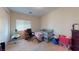Bedroom with carpet, organized with furnishings including a crib, changing table, and office chair at 3425 Fledgling Dr, North Las Vegas, NV 89084