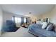 Spacious bedroom with plush carpet, entertainment center, sitting area, and large window for a relaxing retreat at 3425 Fledgling Dr, North Las Vegas, NV 89084