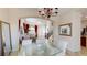 Elegant dining room featuring a glass table, plush chairs, and view into the adjacent living room at 3425 Fledgling Dr, North Las Vegas, NV 89084