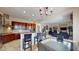 Open kitchen with stainless steel appliances, granite countertops, and breakfast bar overlooking the living area at 3425 Fledgling Dr, North Las Vegas, NV 89084