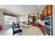 Modern kitchen featuring wooden cabinetry, granite countertops, stainless steel appliances, and tile flooring at 3425 Fledgling Dr, North Las Vegas, NV 89084