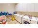 Functional laundry room with ample storage, a sink, and modern appliances at 3425 Fledgling Dr, North Las Vegas, NV 89084