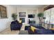 Bright living room features a fireplace, neutral walls, tile floors, and comfortable furnishings at 3425 Fledgling Dr, North Las Vegas, NV 89084