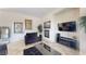 Cozy living room with tile flooring, fireplace, wall art, and a modern entertainment center at 3425 Fledgling Dr, North Las Vegas, NV 89084