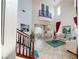 Elegant living room with high ceilings, staircase, and stylish decor for a welcoming ambiance at 3425 Fledgling Dr, North Las Vegas, NV 89084