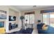 Open-concept living room with tile flooring, TV, modern decor, and sunlit windows at 3425 Fledgling Dr, North Las Vegas, NV 89084