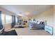 Spacious main bedroom features large windows, comfortable seating, and plush bedding at 3425 Fledgling Dr, North Las Vegas, NV 89084