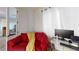 Office space featuring a red sofa, desk area, and bright, natural light at 3425 Fledgling Dr, North Las Vegas, NV 89084
