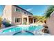 Resort-style backyard with a sparkling pool, spa, and lush greenery for ultimate relaxation at 3425 Fledgling Dr, North Las Vegas, NV 89084
