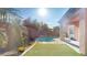 Private backyard oasis featuring a sparkling pool, spa, and lush landscaping at 3425 Fledgling Dr, North Las Vegas, NV 89084
