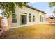 Backyard showcasing sliding glass doors, stucco exterior, and ample space for outdoor activities at 4007 W Red Coach Ave, North Las Vegas, NV 89031