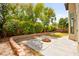 Backyard with a fire pit, lush landscaping, and a patio area ideal for gatherings at 4007 W Red Coach Ave, North Las Vegas, NV 89031