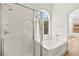 This bathroom features a shower, bathtub, and window letting in natural light at 4007 W Red Coach Ave, North Las Vegas, NV 89031