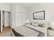 This staged bedroom has great lighting with a luxurious bed and decorative wall art at 4007 W Red Coach Ave, North Las Vegas, NV 89031