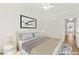 This staged bedroom has a ceiling fan with a view of the closet and entrance at 4007 W Red Coach Ave, North Las Vegas, NV 89031