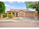 Charming single-story home with a well-manicured front yard and a two-car garage at 4007 W Red Coach Ave, North Las Vegas, NV 89031